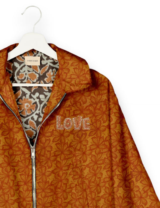 Love Bomber Jacket made from recycled fabric, featuring hand-stitched Aari embroidery. A unique piece of zero-waste clothing, part of the circular fashion movement. Designed with upcycled materials for a stylish yet environmentally friendly clothing choice.