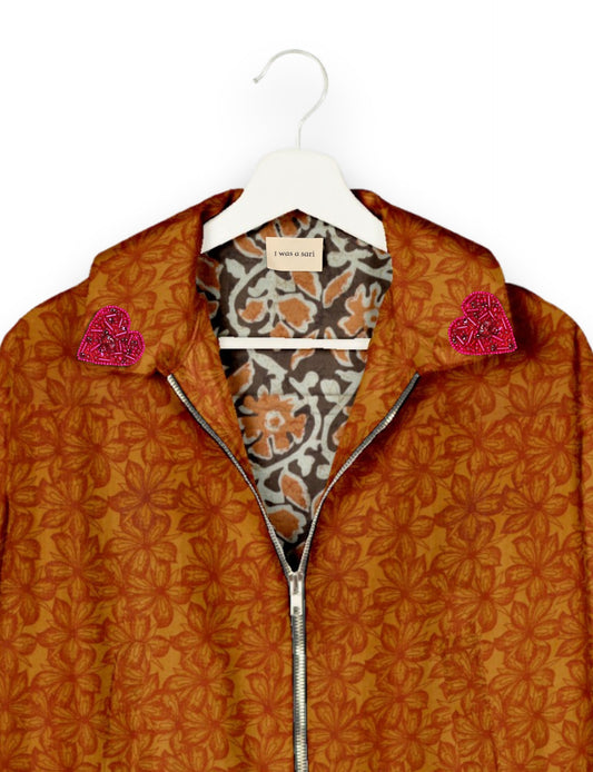 Make a bold statement with our Heart Drop Earrings, a symbol of conscious luxury and ethical fashion. Handcrafted using the intricate Aari embroidery technique, these earrings are made from upcycled sari fabric, embracing slow fashion and zero waste clothing. Elevate your look with sustainable apparel that supports fair trade fashion while reducing textile waste. Choose eco-friendly fashion that speaks of love, artistry, and responsibility.