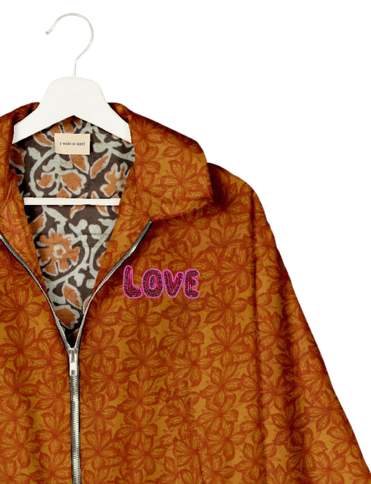 Love Bomber Jacket made from recycled fabric, featuring hand-stitched Aari embroidery. A unique piece of zero-waste clothing, part of the circular fashion movement. Designed with upcycled materials for a stylish yet environmentally friendly clothing choice.