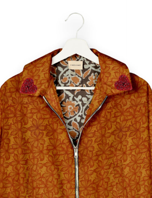 Make a bold statement with our Heart Drop Earrings, a symbol of conscious luxury and ethical fashion. Handcrafted using the intricate Aari embroidery technique, these earrings are made from upcycled sari fabric, embracing slow fashion and zero waste clothing. Elevate your look with sustainable apparel that supports fair trade fashion while reducing textile waste. Choose eco-friendly fashion that speaks of love, artistry, and responsibility.