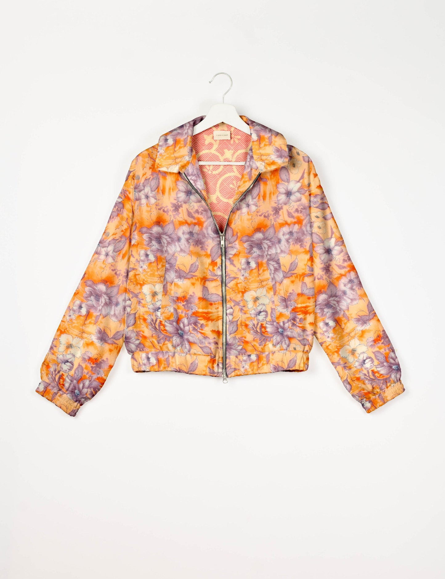 Stylish BOMBER JACKET, an upcycled clothing masterpiece with a cute cropped shape, elasticated details, and detachable metallic zipper. Contrast sari print lining adds a unique touch. Explore sustainable and eco-friendly fashion.