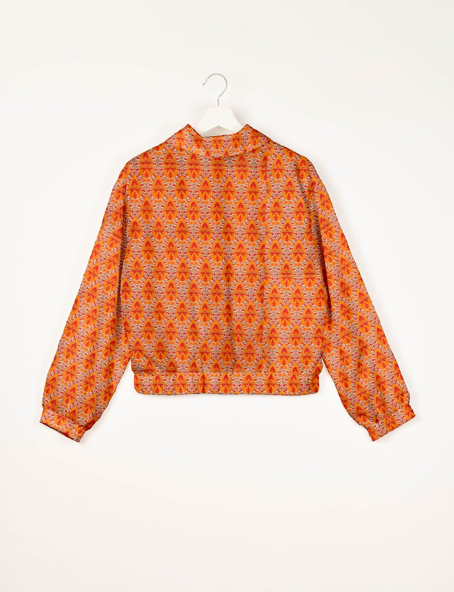 Stylish BOMBER JACKET, an upcycled clothing masterpiece with a cute cropped shape, elasticated details, and detachable metallic zipper. Contrast sari print lining adds a unique touch. Explore sustainable and eco-friendly fashion.