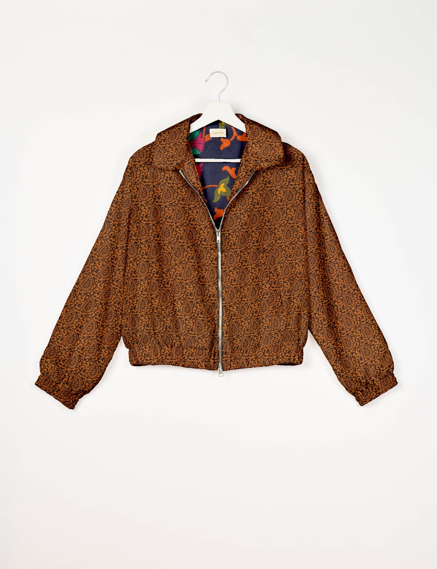 Upcycled Bomber Jacket made from recycled sari materials, featuring a cute cropped shape, elasticated hem and cuffs, and contrast sari print lining. Sustainable apparel promoting eco-friendly fashion and ethical clothing.