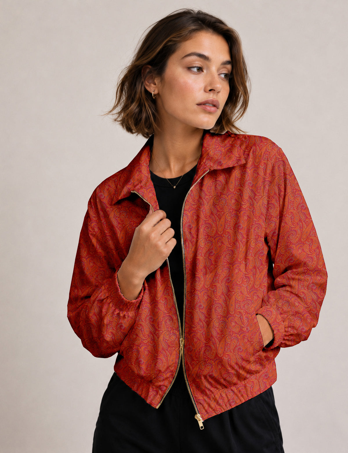 Woman wearing a yellow floral bomber jacket with front zipper, elastic cuffs, and side pockets, shown from front view