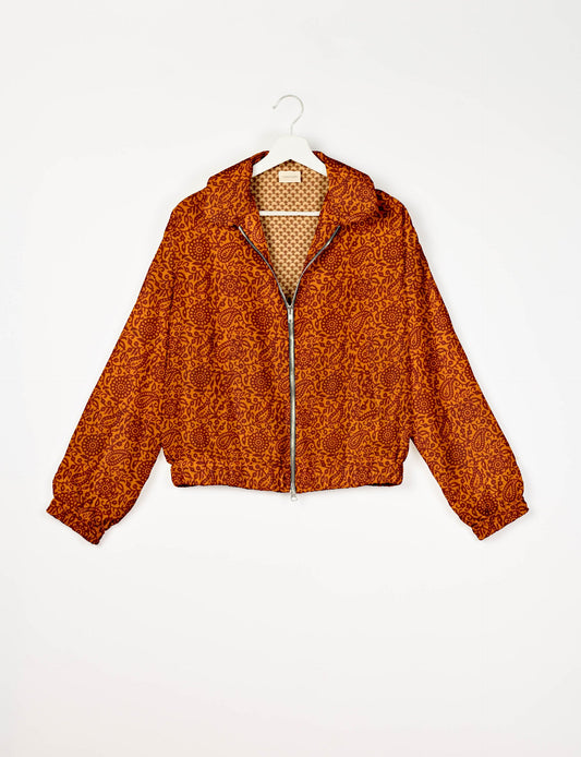 Stylish BOMBER JACKET, an upcycled clothing masterpiece with a cute cropped shape, elasticated details, and detachable metallic zipper. Contrast sari print lining adds a unique touch. Explore sustainable and eco-friendly fashion.