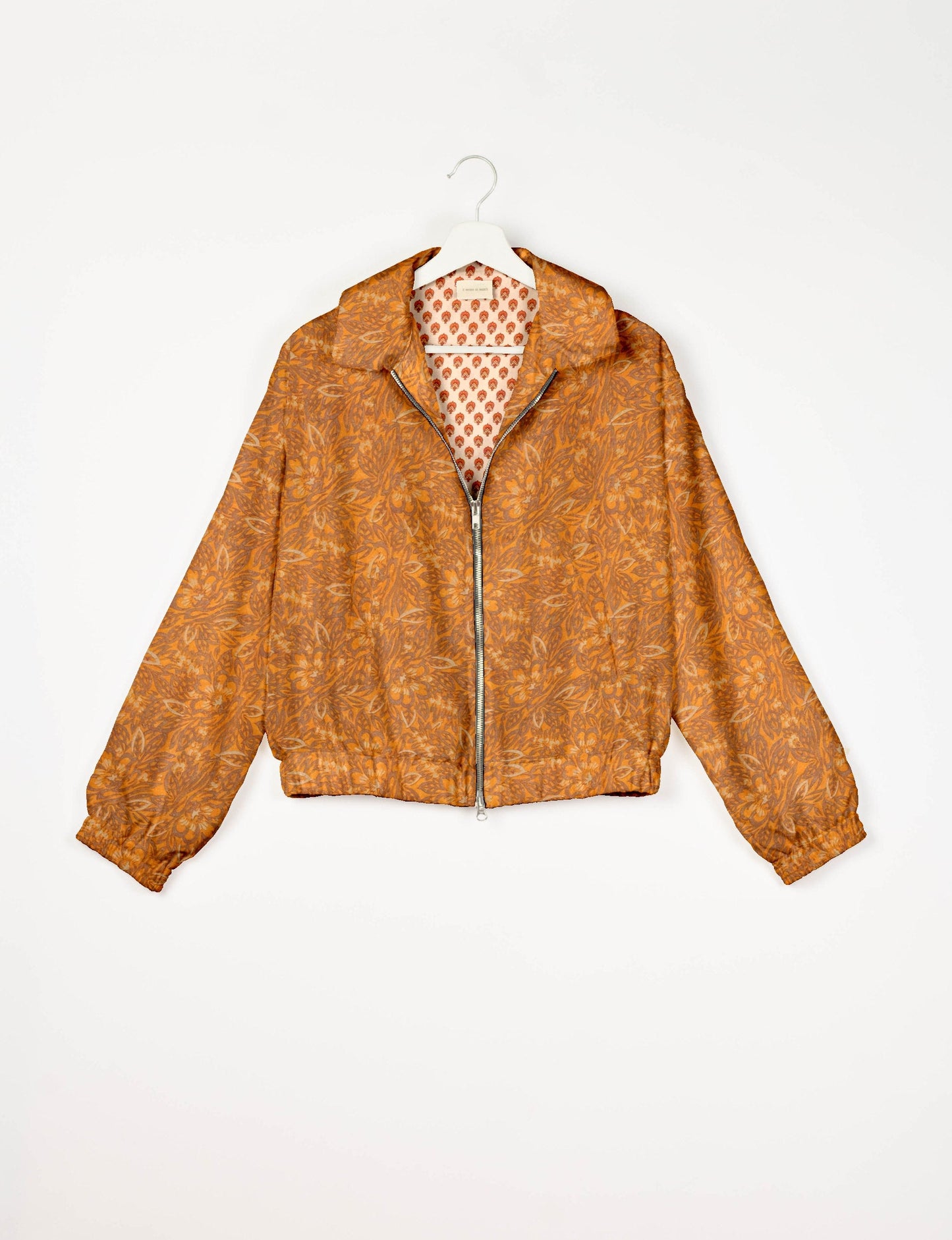 Stylish BOMBER JACKET, an upcycled clothing masterpiece with a cute cropped shape, elasticated details, and detachable metallic zipper. Contrast sari print lining adds a unique touch. Explore sustainable and eco-friendly fashion.