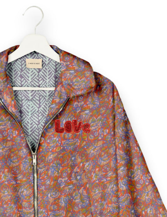 Love Bomber Jacket made from recycled fabric, featuring hand-stitched Aari embroidery. A unique piece of zero-waste clothing, part of the circular fashion movement. Designed with upcycled materials for a stylish yet environmentally friendly clothing choice.