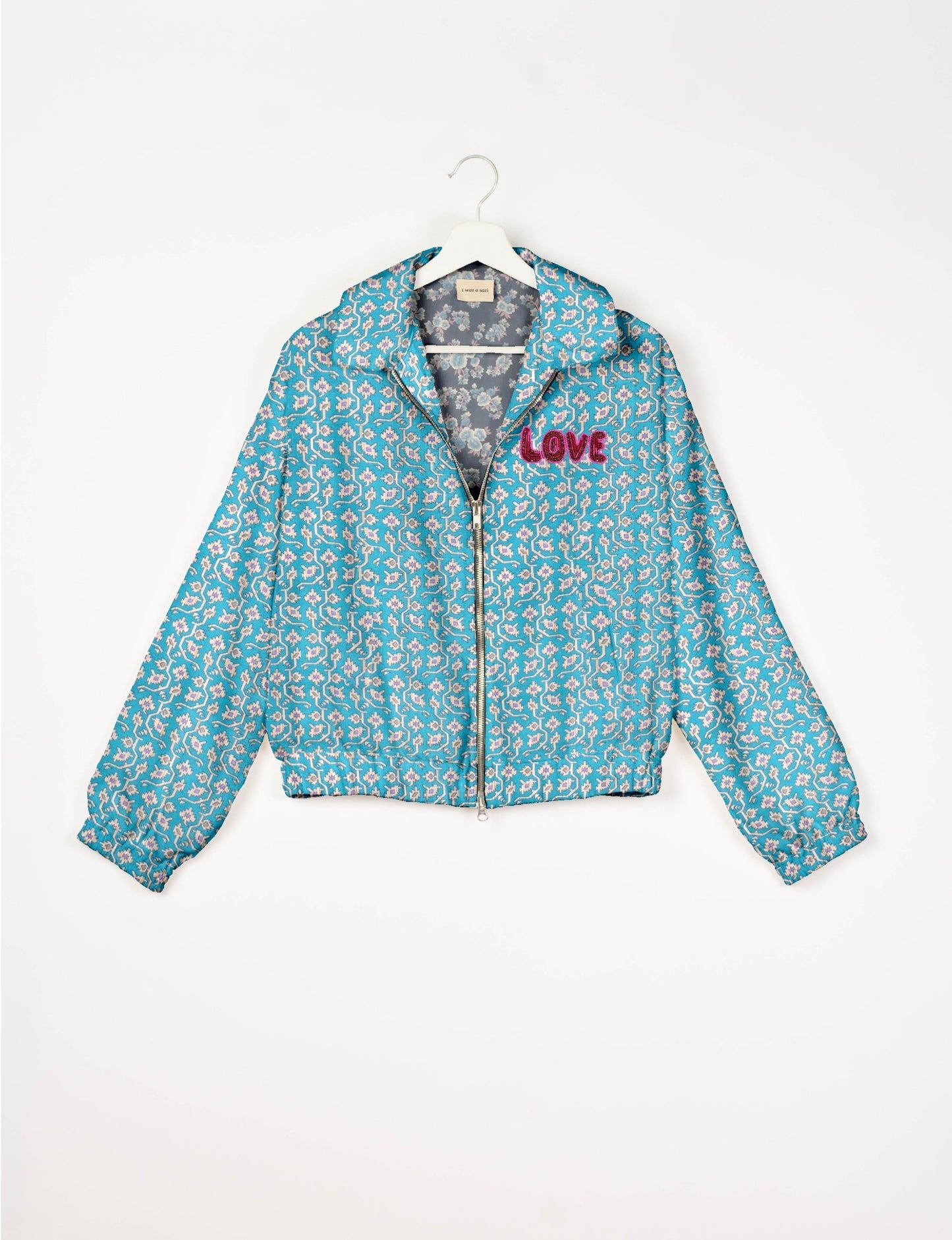 Love Bomber Jacket made from recycled fabric, featuring hand-stitched Aari embroidery. A unique piece of zero-waste clothing, part of the circular fashion movement. Designed with upcycled materials for a stylish yet environmentally friendly clothing choice.