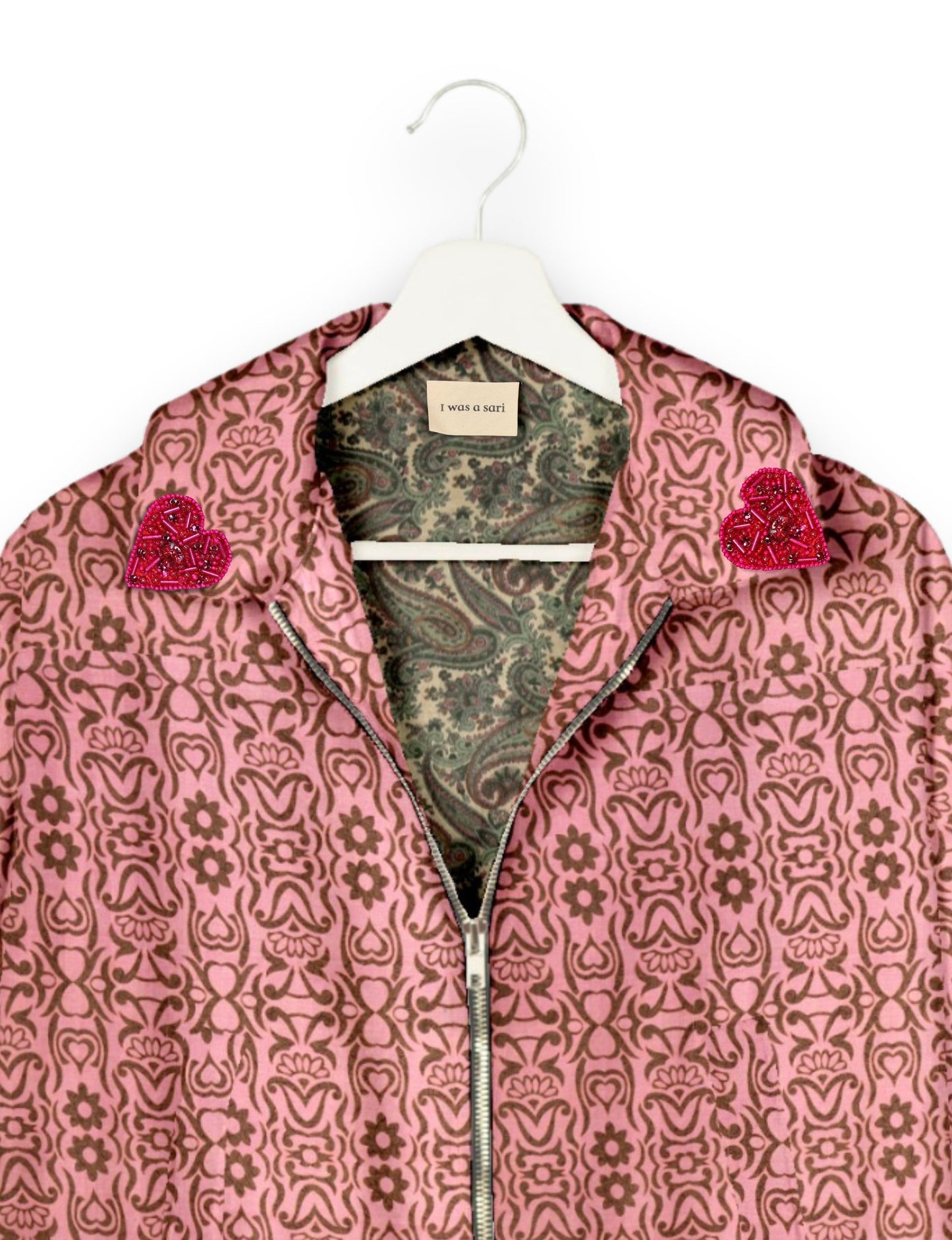 Make a bold statement with our Heart Drop Earrings, a symbol of conscious luxury and ethical fashion. Handcrafted using the intricate Aari embroidery technique, these earrings are made from upcycled sari fabric, embracing slow fashion and zero waste clothing. Elevate your look with sustainable apparel that supports fair trade fashion while reducing textile waste. Choose eco-friendly fashion that speaks of love, artistry, and responsibility.