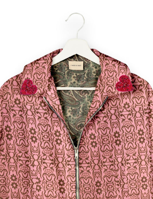 Make a bold statement with our Heart Drop Earrings, a symbol of conscious luxury and ethical fashion. Handcrafted using the intricate Aari embroidery technique, these earrings are made from upcycled sari fabric, embracing slow fashion and zero waste clothing. Elevate your look with sustainable apparel that supports fair trade fashion while reducing textile waste. Choose eco-friendly fashion that speaks of love, artistry, and responsibility.