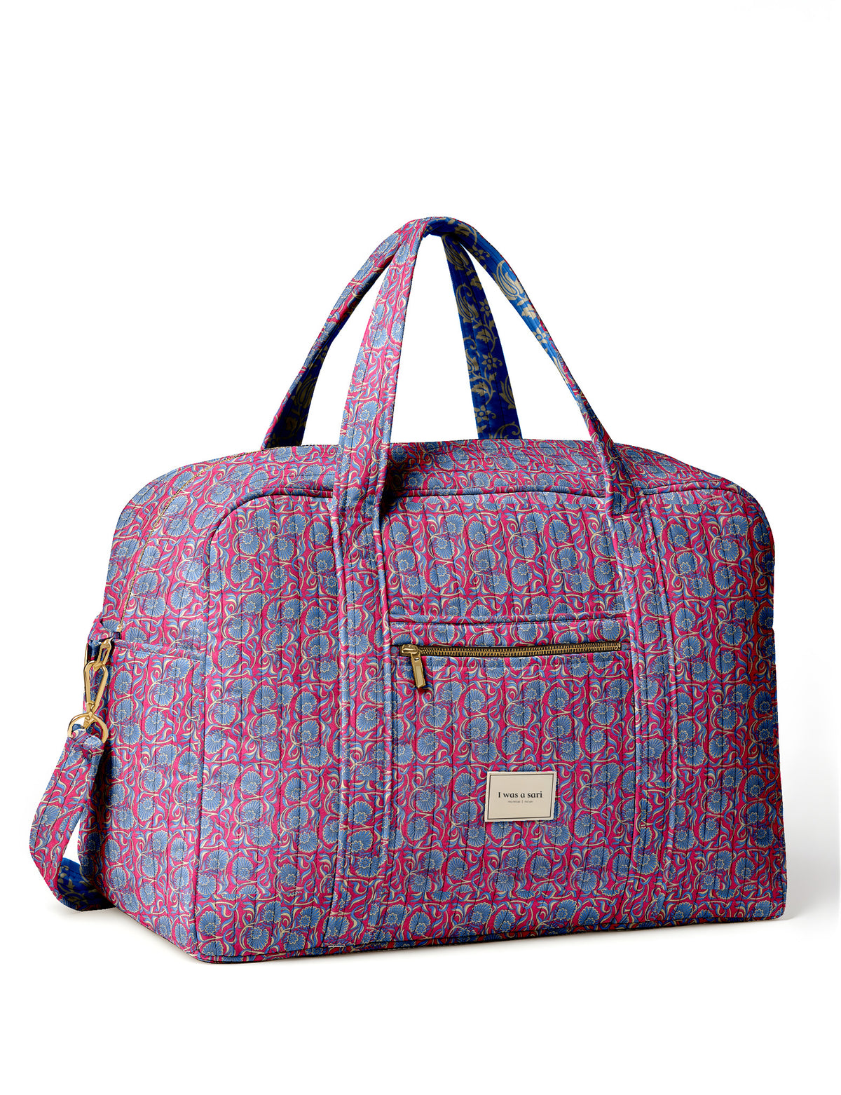 Brown quilted duffle bag with paisley pattern, front zip pocket, dual handles, and label reading "I was a sari"