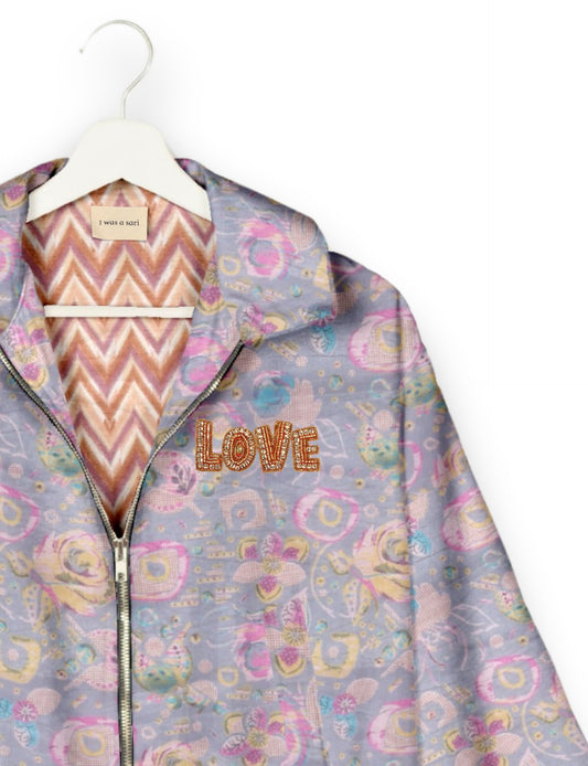 Love Bomber Jacket made from recycled fabric, featuring hand-stitched Aari embroidery. A unique piece of zero-waste clothing, part of the circular fashion movement. Designed with upcycled materials for a stylish yet environmentally friendly clothing choice.