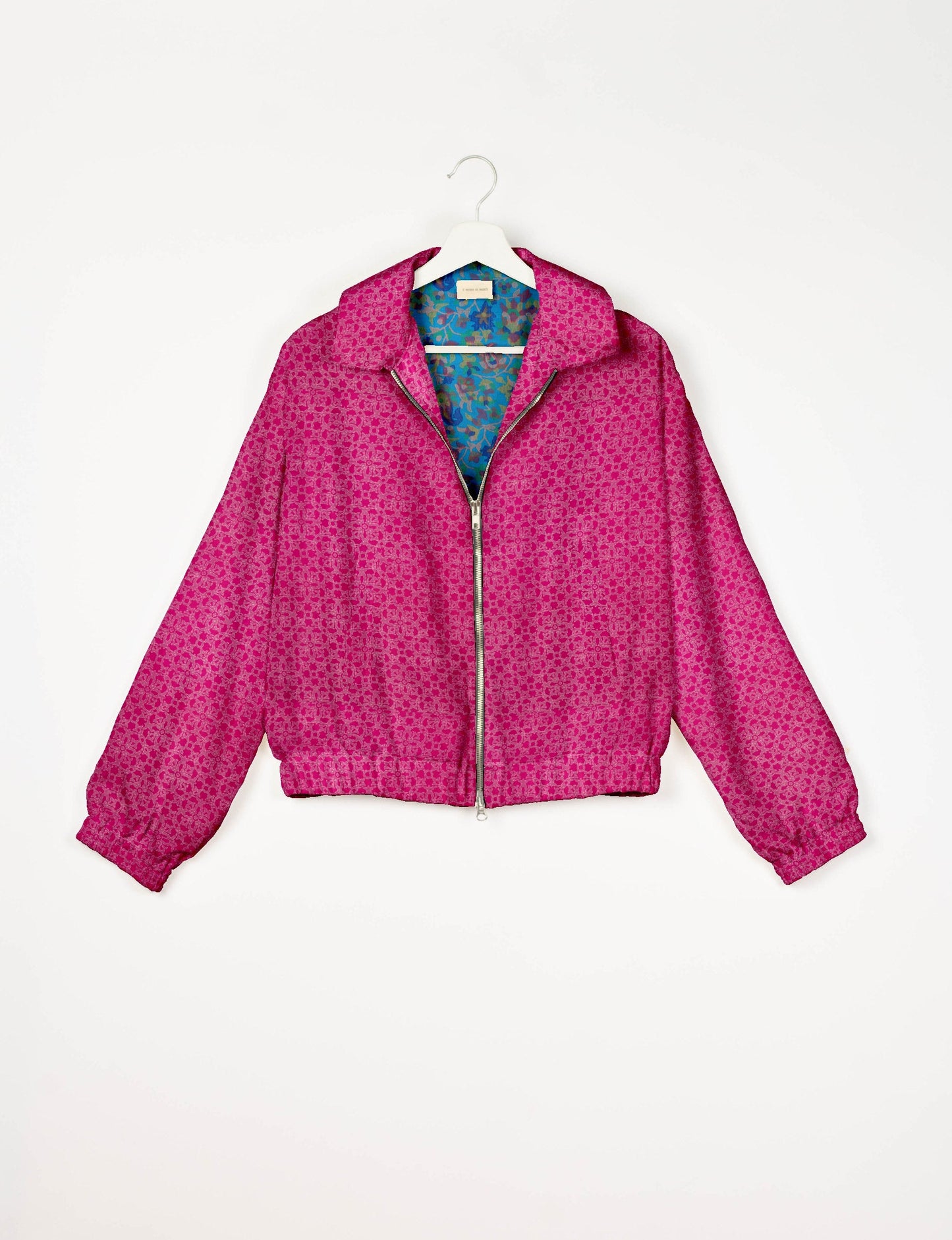 Upcycled Bomber Jacket made from recycled sari materials, featuring a cute cropped shape, elasticated hem and cuffs, and contrast sari print lining. Sustainable apparel promoting eco-friendly fashion and ethical clothing.