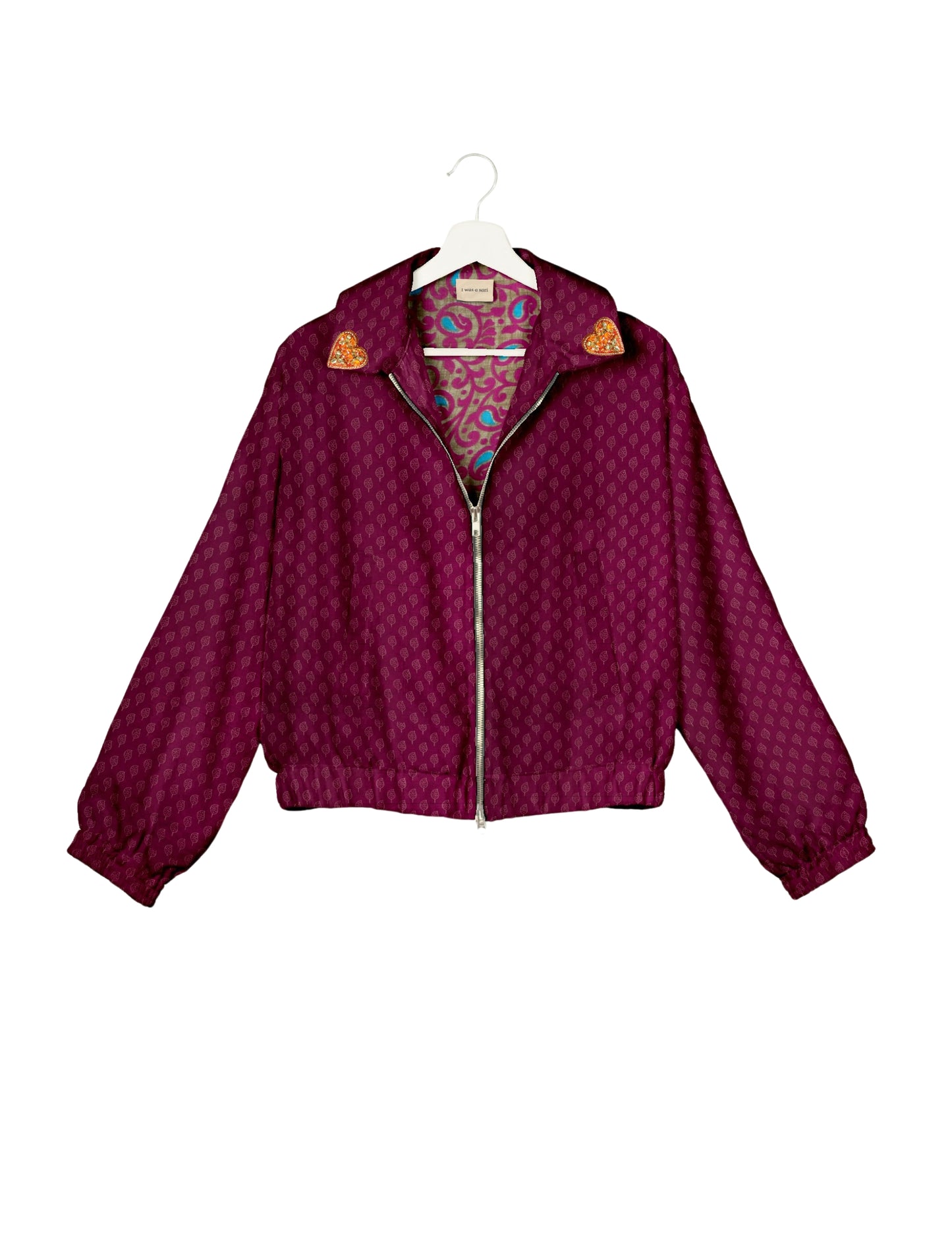 Make a bold statement with our Heart Drop Earrings, a symbol of conscious luxury and ethical fashion. Handcrafted using the intricate Aari embroidery technique, these earrings are made from upcycled sari fabric, embracing slow fashion and zero waste clothing. Elevate your look with sustainable apparel that supports fair trade fashion while reducing textile waste. Choose eco-friendly fashion that speaks of love, artistry, and responsibility.