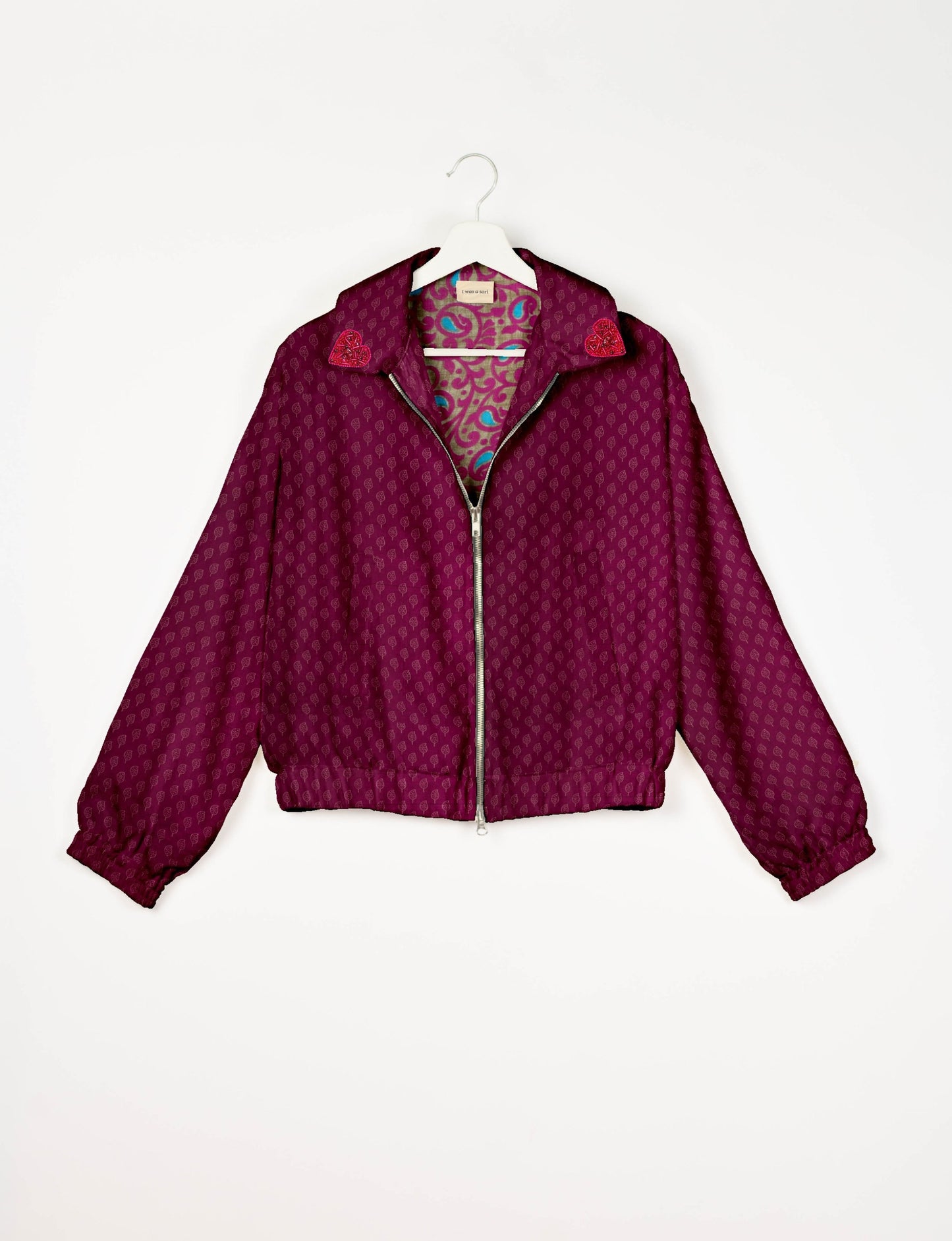 Make a bold statement with our Heart Drop Earrings, a symbol of conscious luxury and ethical fashion. Handcrafted using the intricate Aari embroidery technique, these earrings are made from upcycled sari fabric, embracing slow fashion and zero waste clothing. Elevate your look with sustainable apparel that supports fair trade fashion while reducing textile waste. Choose eco-friendly fashion that speaks of love, artistry, and responsibility.