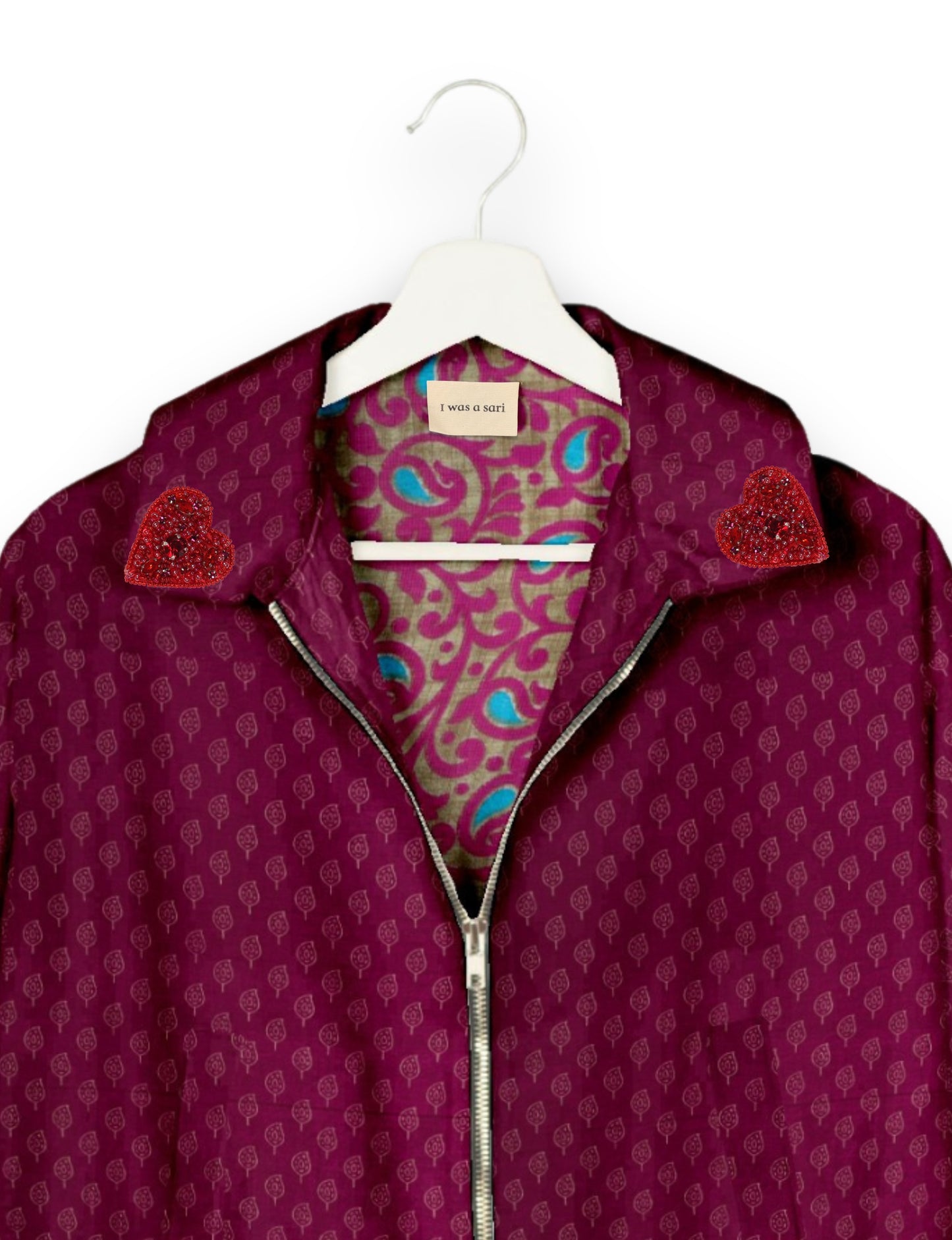 Make a bold statement with our Heart Drop Earrings, a symbol of conscious luxury and ethical fashion. Handcrafted using the intricate Aari embroidery technique, these earrings are made from upcycled sari fabric, embracing slow fashion and zero waste clothing. Elevate your look with sustainable apparel that supports fair trade fashion while reducing textile waste. Choose eco-friendly fashion that speaks of love, artistry, and responsibility.