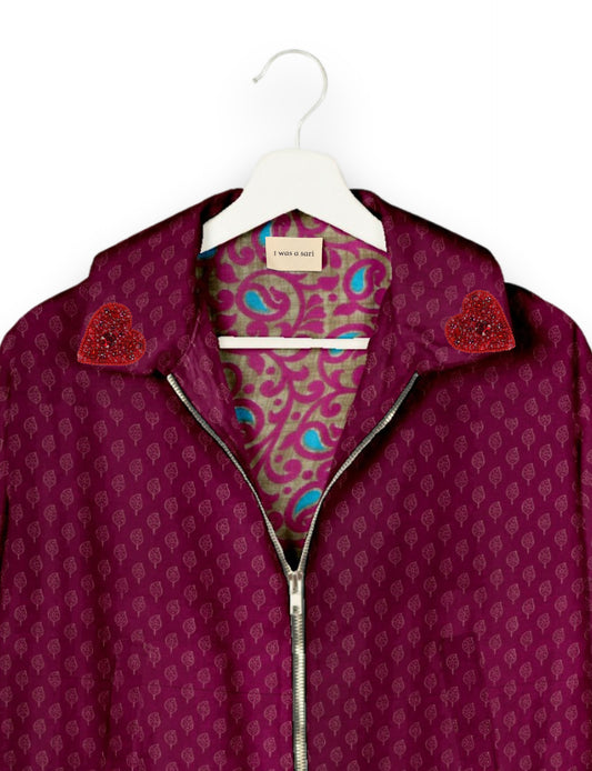 Make a bold statement with our Heart Drop Earrings, a symbol of conscious luxury and ethical fashion. Handcrafted using the intricate Aari embroidery technique, these earrings are made from upcycled sari fabric, embracing slow fashion and zero waste clothing. Elevate your look with sustainable apparel that supports fair trade fashion while reducing textile waste. Choose eco-friendly fashion that speaks of love, artistry, and responsibility.