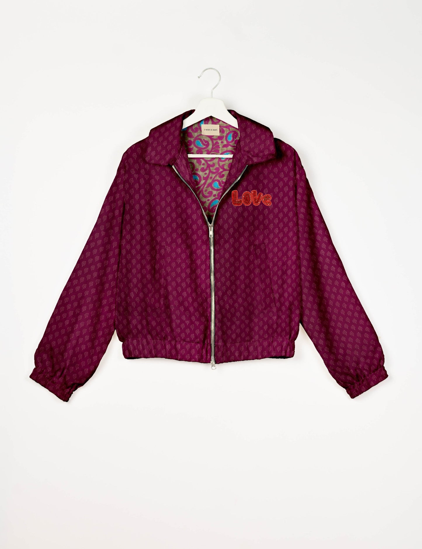 Love Bomber Jacket made from recycled fabric, featuring hand-stitched Aari embroidery. A unique piece of zero-waste clothing, part of the circular fashion movement. Designed with upcycled materials for a stylish yet environmentally friendly clothing choice.