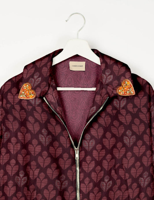 Make a bold statement with our Heart Drop Earrings, a symbol of conscious luxury and ethical fashion. Handcrafted using the intricate Aari embroidery technique, these earrings are made from upcycled sari fabric, embracing slow fashion and zero waste clothing. Elevate your look with sustainable apparel that supports fair trade fashion while reducing textile waste. Choose eco-friendly fashion that speaks of love, artistry, and responsibility.