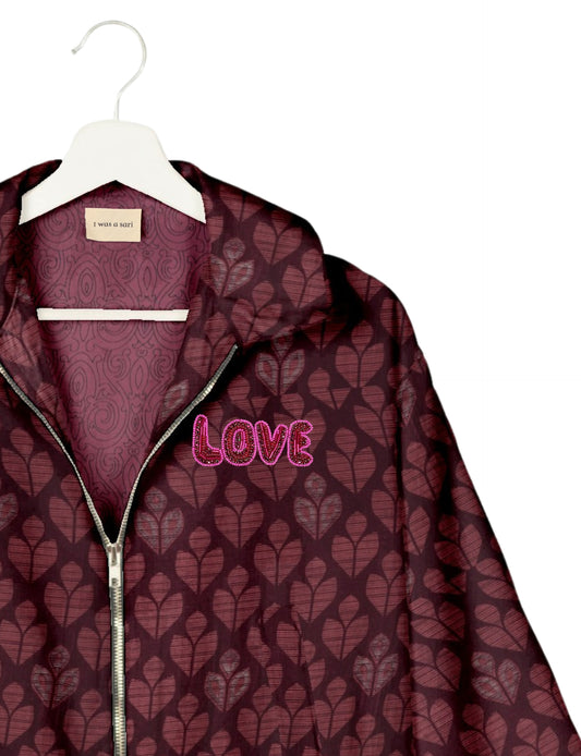 Love Bomber Jacket made from recycled fabric, featuring hand-stitched Aari embroidery. A unique piece of zero-waste clothing, part of the circular fashion movement. Designed with upcycled materials for a stylish yet environmentally friendly clothing choice.