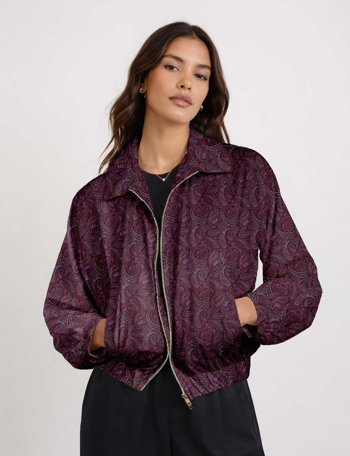 Brown floral bomber jacket with front zipper, elastic cuffs and hem, hanging on white hanger, red floral inner lining visible