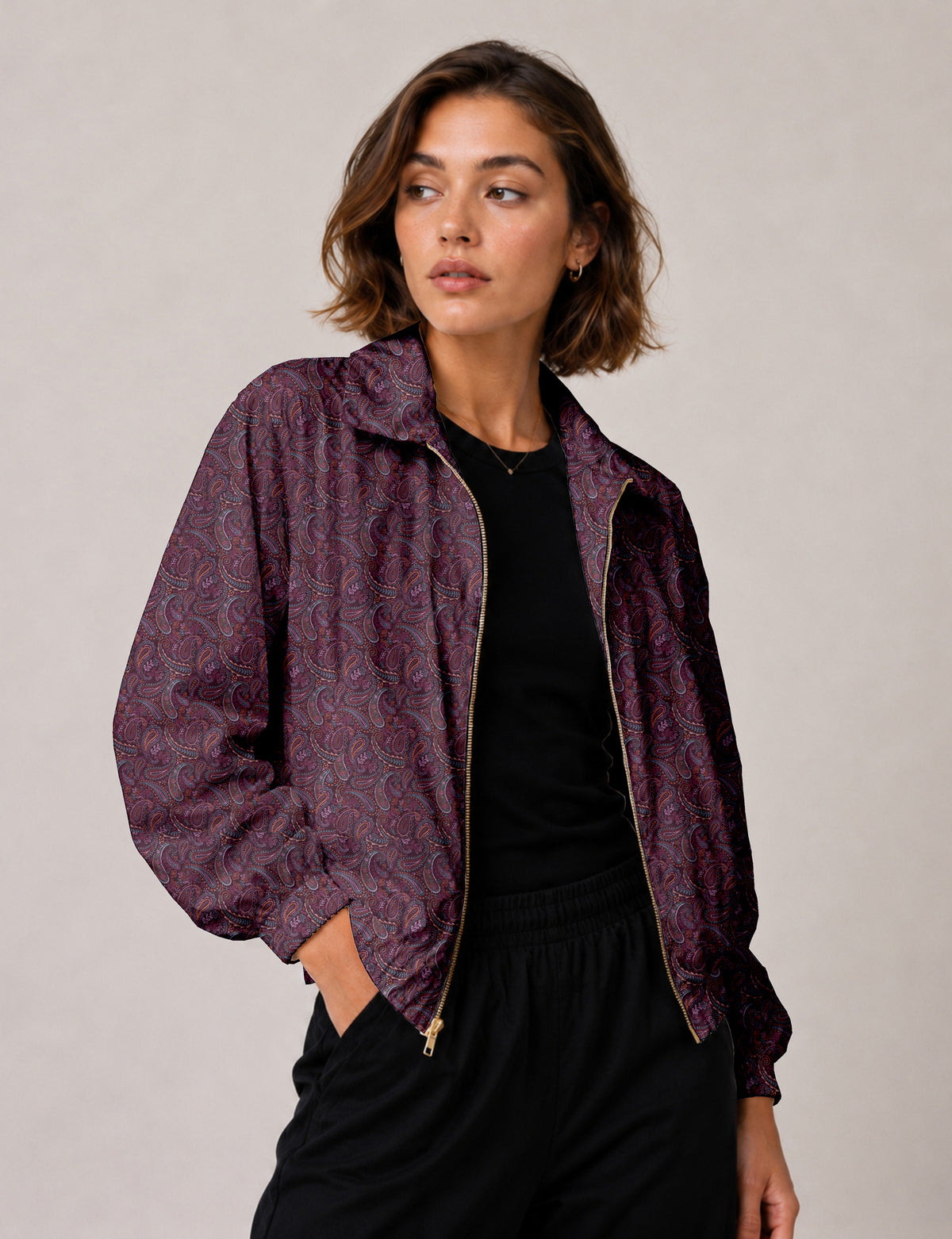 Woman wearing a yellow floral bomber jacket with front zipper, elastic cuffs, and side pockets, shown from front view