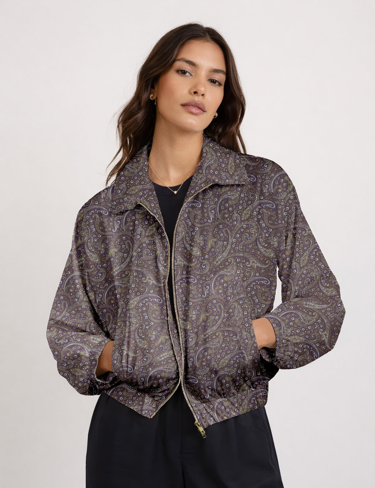 Brown floral bomber jacket with front zipper, elastic cuffs and hem, hanging on white hanger, red floral inner lining visible