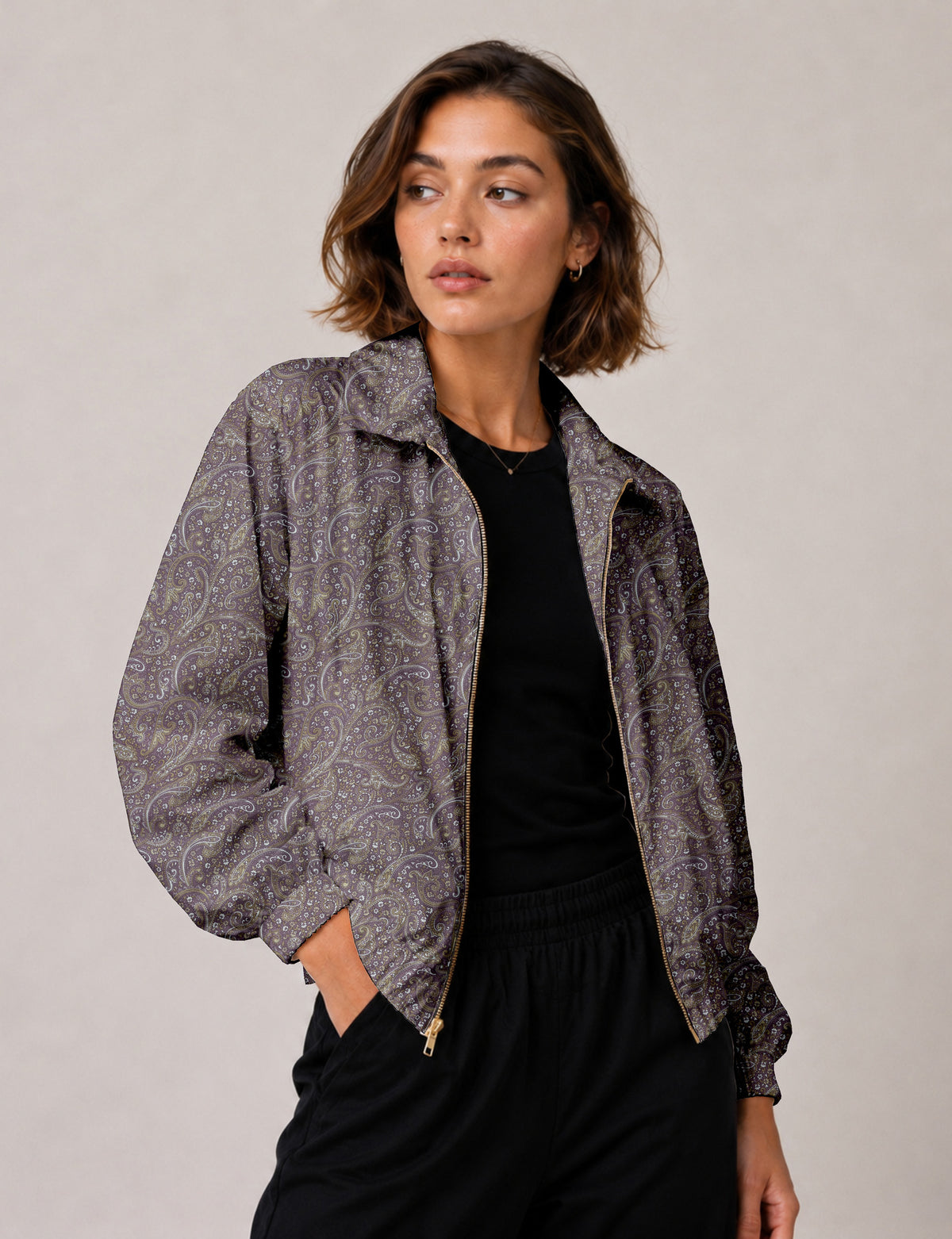 Brown floral bomber jacket with front zipper, elastic cuffs and hem, hanging on white hanger, red floral inner lining visible