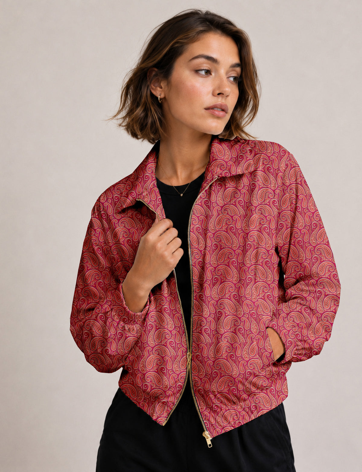 Woman wearing a yellow floral bomber jacket with front zipper, elastic cuffs, and side pockets, shown from front view