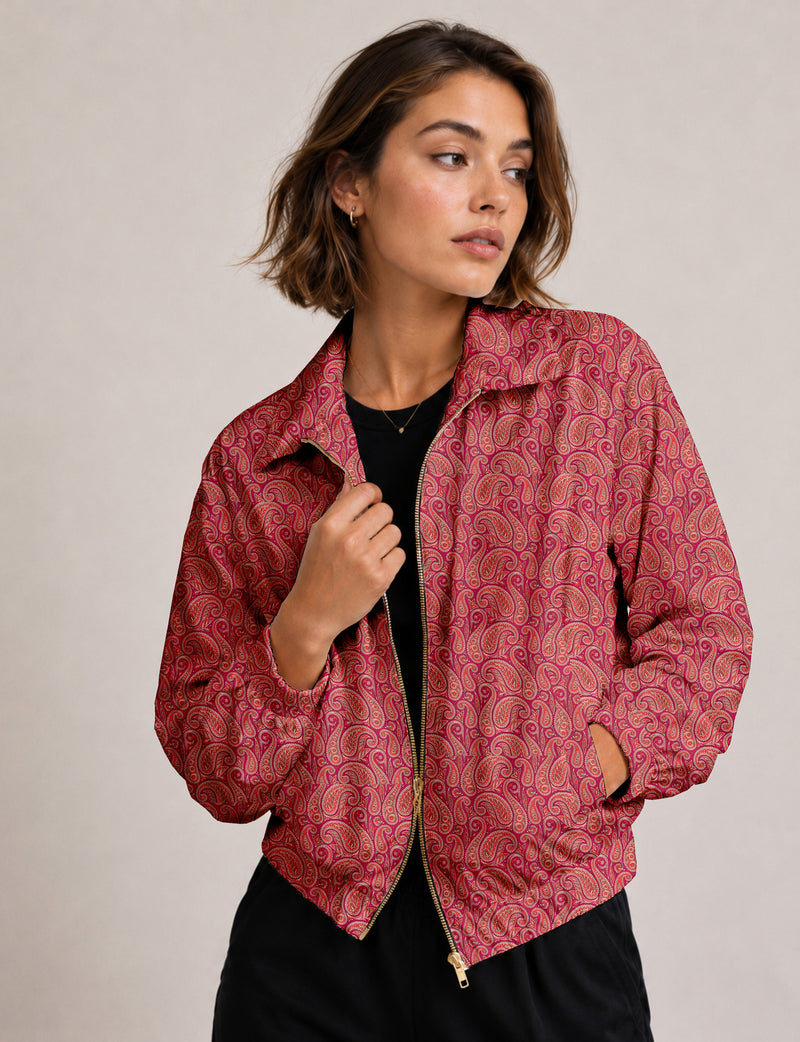 Woman wearing a yellow floral bomber jacket with front zipper, elastic cuffs, and side pockets, shown from front view