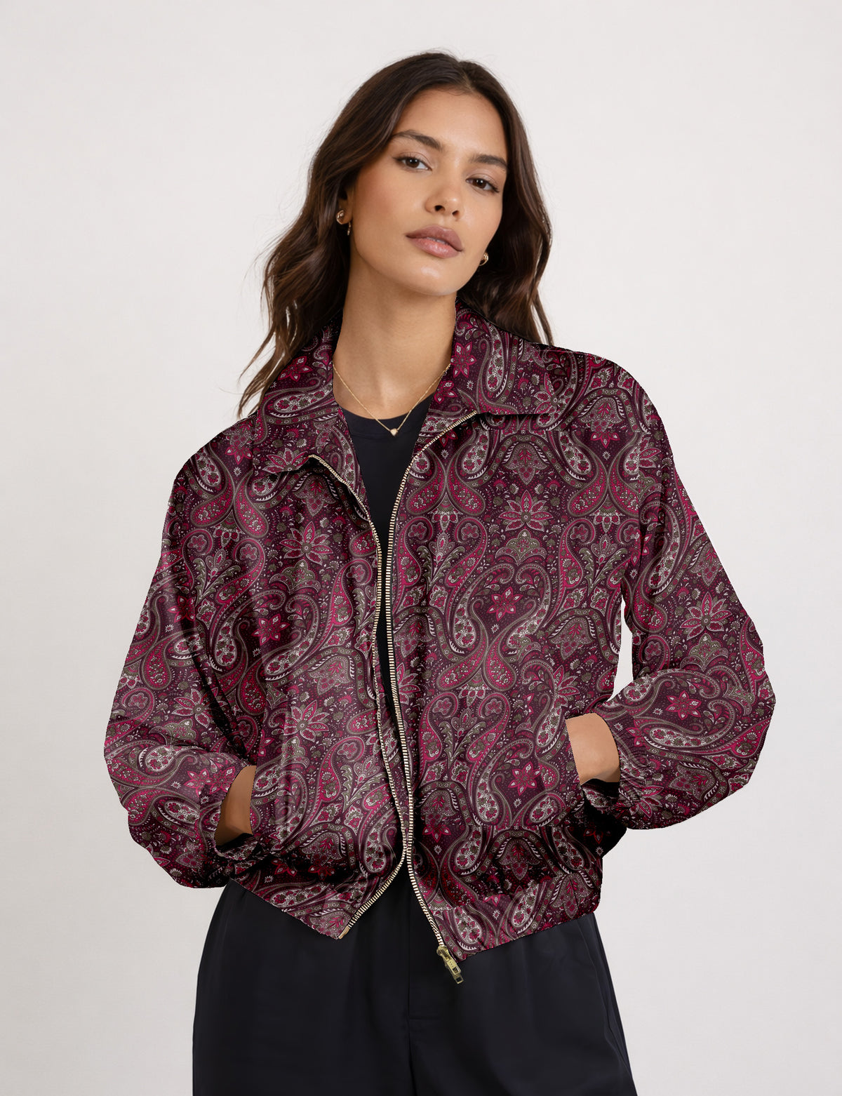 Woman wearing a yellow floral bomber jacket with front zipper, elastic cuffs, and side pockets, shown from front view