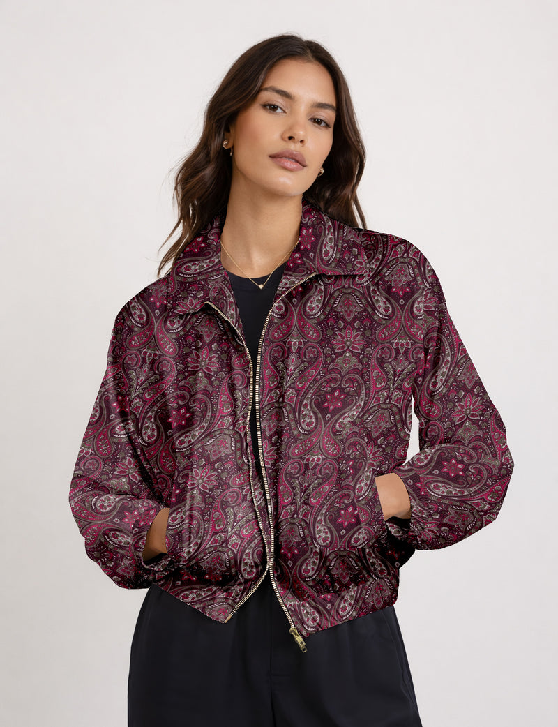 Woman wearing a yellow floral bomber jacket with front zipper, elastic cuffs, and side pockets, shown from front view