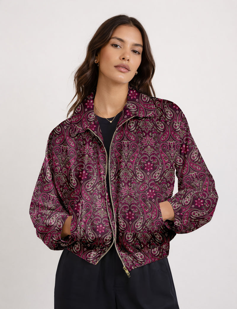 Woman wearing a yellow floral bomber jacket with front zipper, elastic cuffs, and side pockets, shown from front view