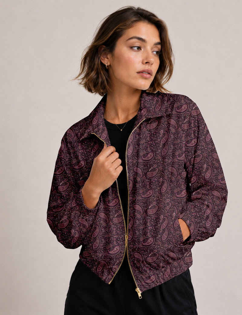 Brown floral bomber jacket with front zipper, elastic cuffs and hem, hanging on white hanger, red floral inner lining visible