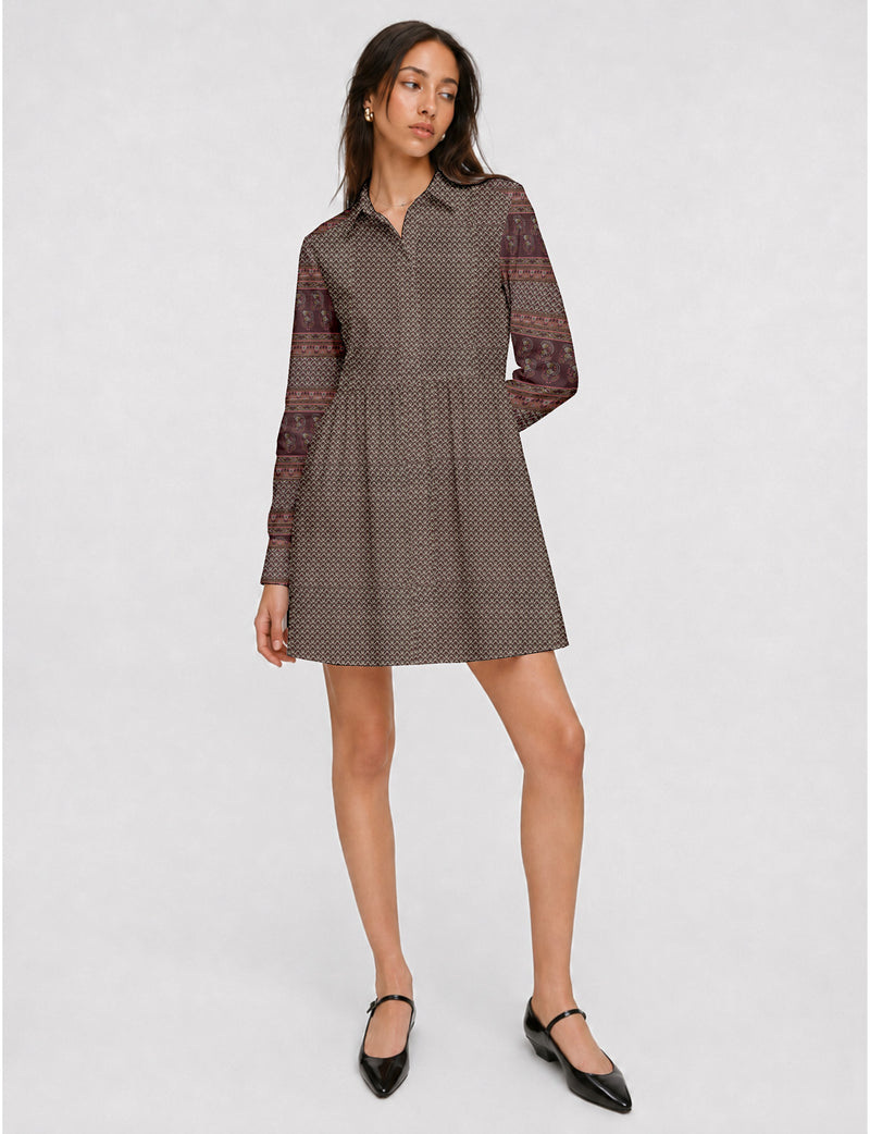 Short shirt dress with a relaxed A-line silhouette, point collar, partial button placket, gathered waist, side pockets, and full-length cuffed sleeves.