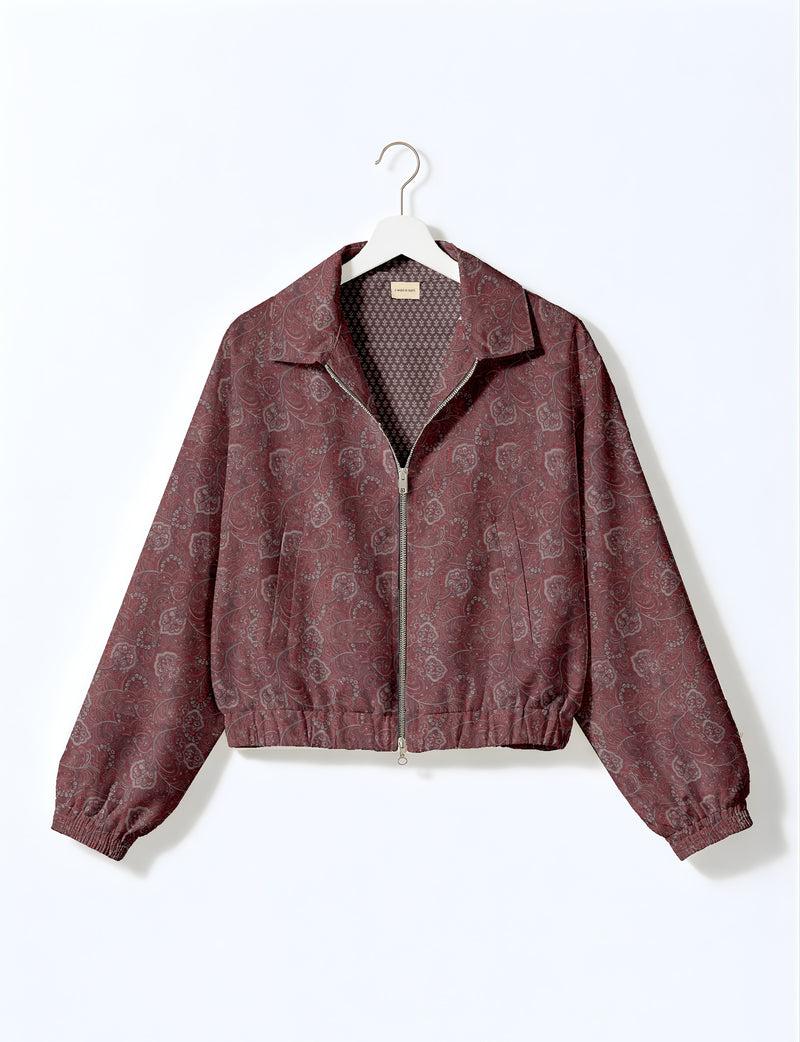 Brown floral bomber jacket with front zipper, elastic cuffs and hem, hanging on white hanger, red floral inner lining visible