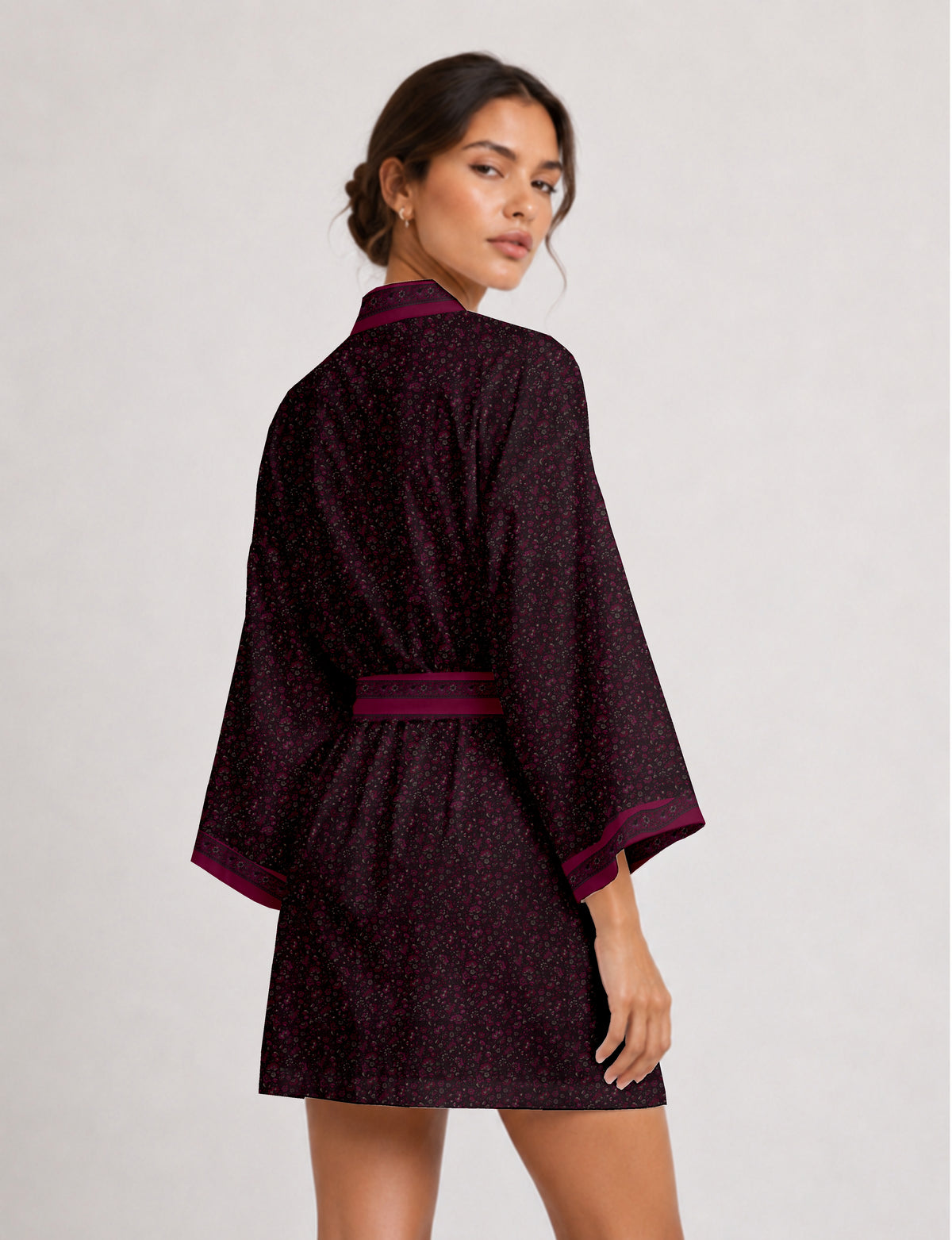 Short kimono robe with wrap front, V-neckline, wide sleeves, waist tie, and concealed skort detail.
