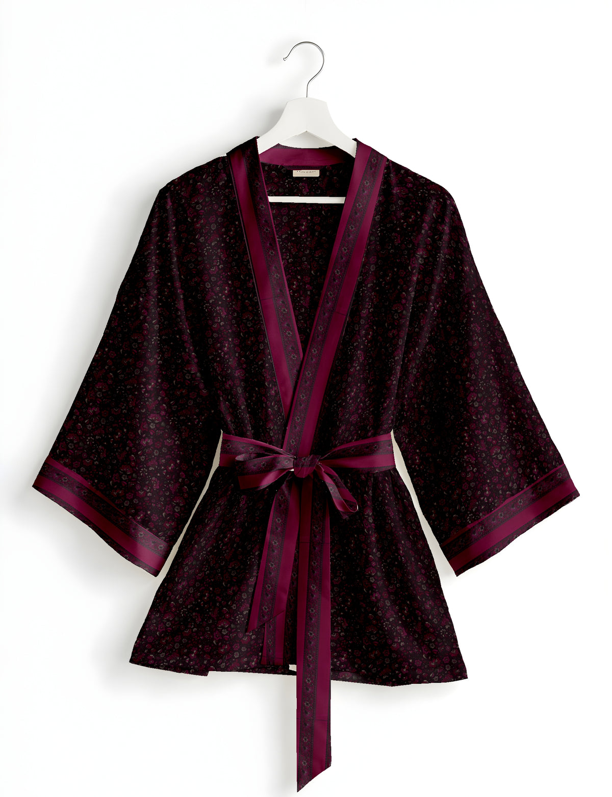 Short kimono robe with wrap front, V-neckline, wide sleeves, waist tie, and concealed skort detail.