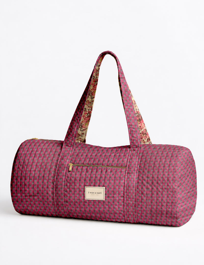 Quilted brown paisley bowling bag with gold zipper, floral interior lining, and interior key clip with label inside pocket
