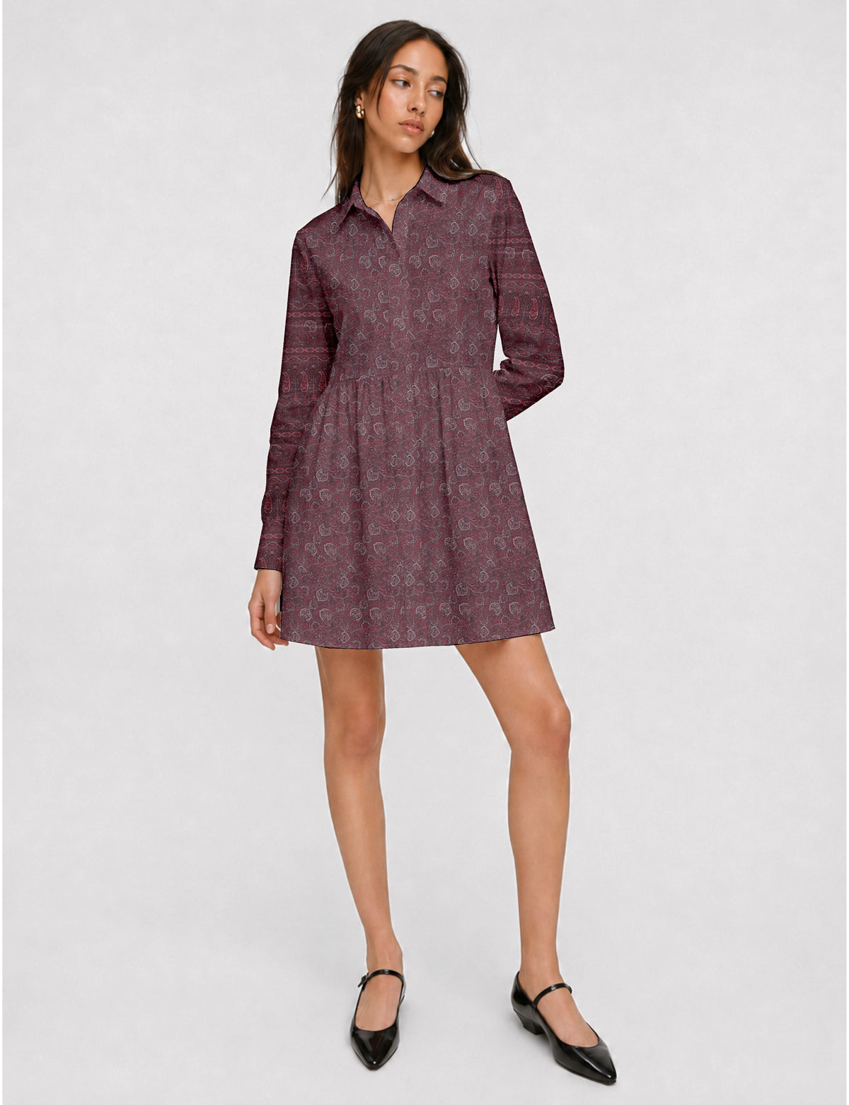 Short shirt dress with a relaxed A-line silhouette, point collar, partial button placket, gathered waist, side pockets, and full-length cuffed sleeves.
