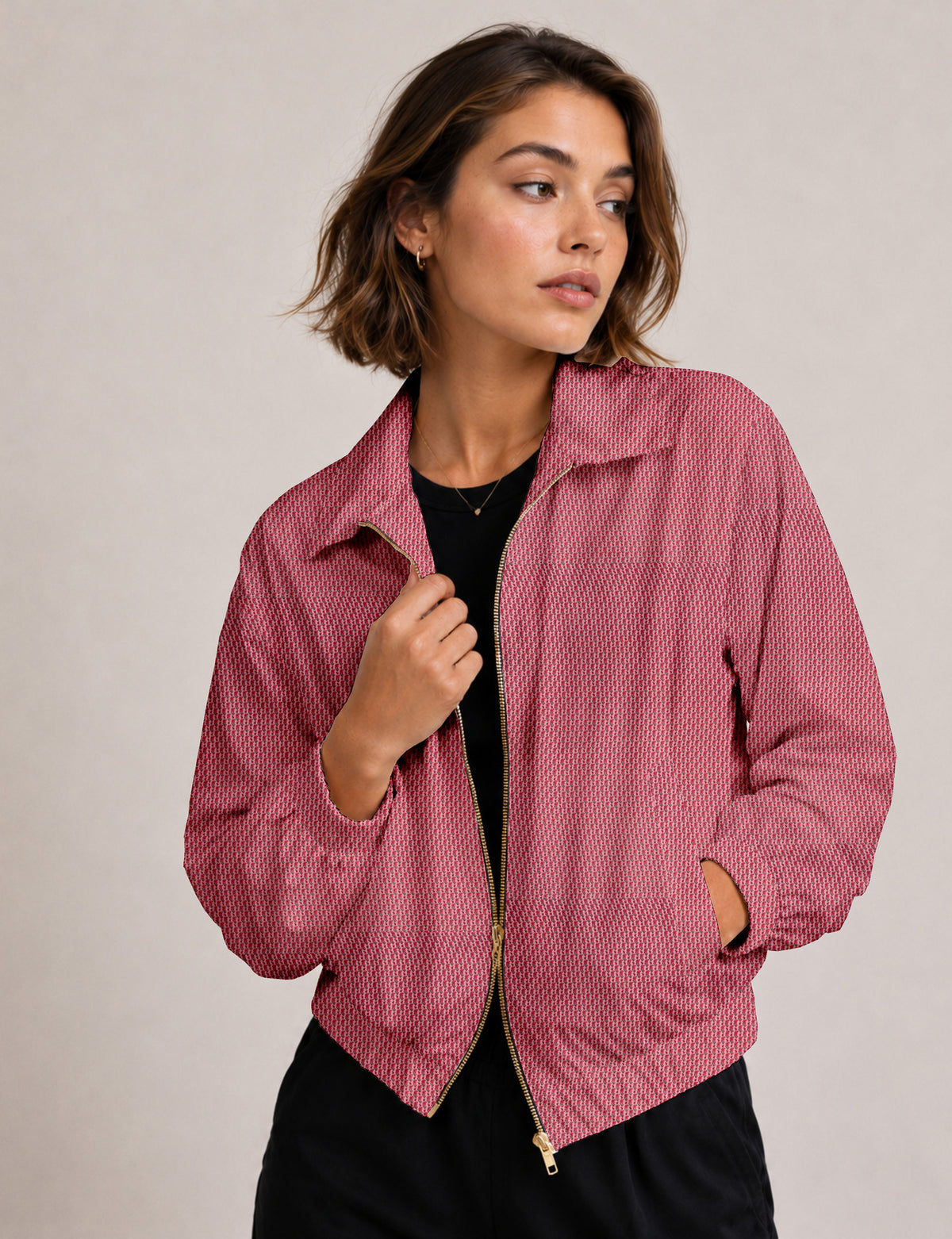 Brown floral bomber jacket with front zipper, elastic cuffs and hem, hanging on white hanger, red floral inner lining visible