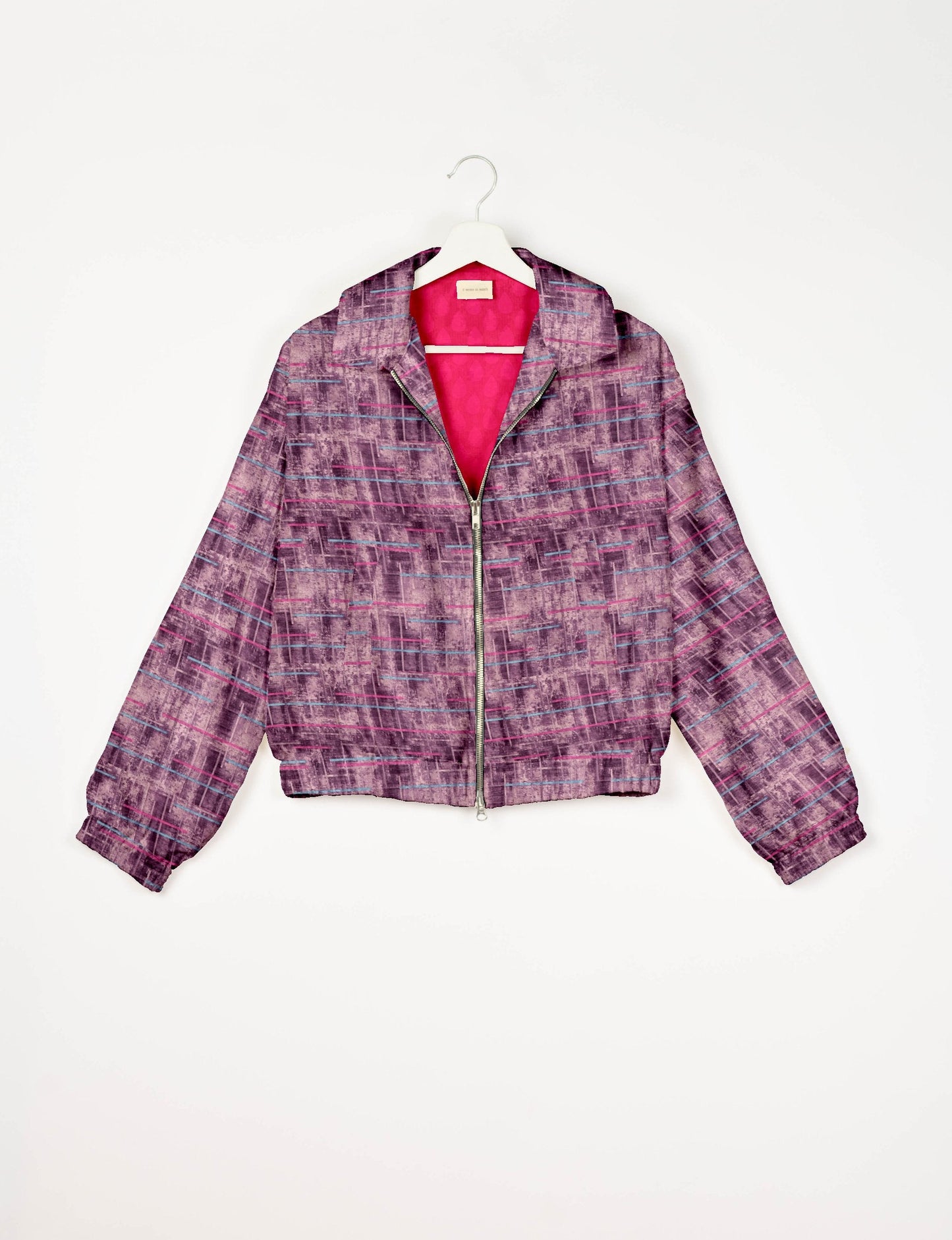 Stylish BOMBER JACKET, an upcycled clothing masterpiece with a cute cropped shape, elasticated details, and detachable metallic zipper. Contrast sari print lining adds a unique touch. Explore sustainable and eco-friendly fashion.