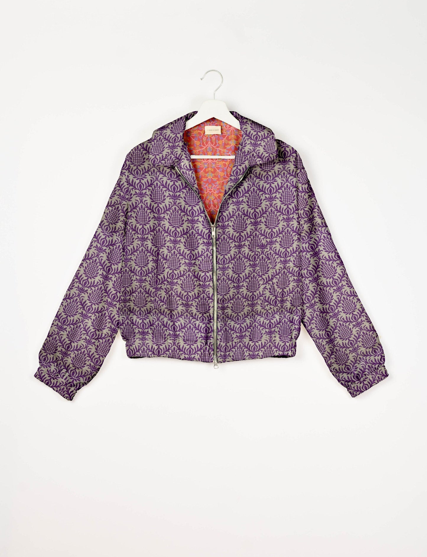 Upcycled Bomber Jacket made from recycled sari materials, featuring a cute cropped shape, elasticated hem and cuffs, and contrast sari print lining. Sustainable apparel promoting eco-friendly fashion and ethical clothing.