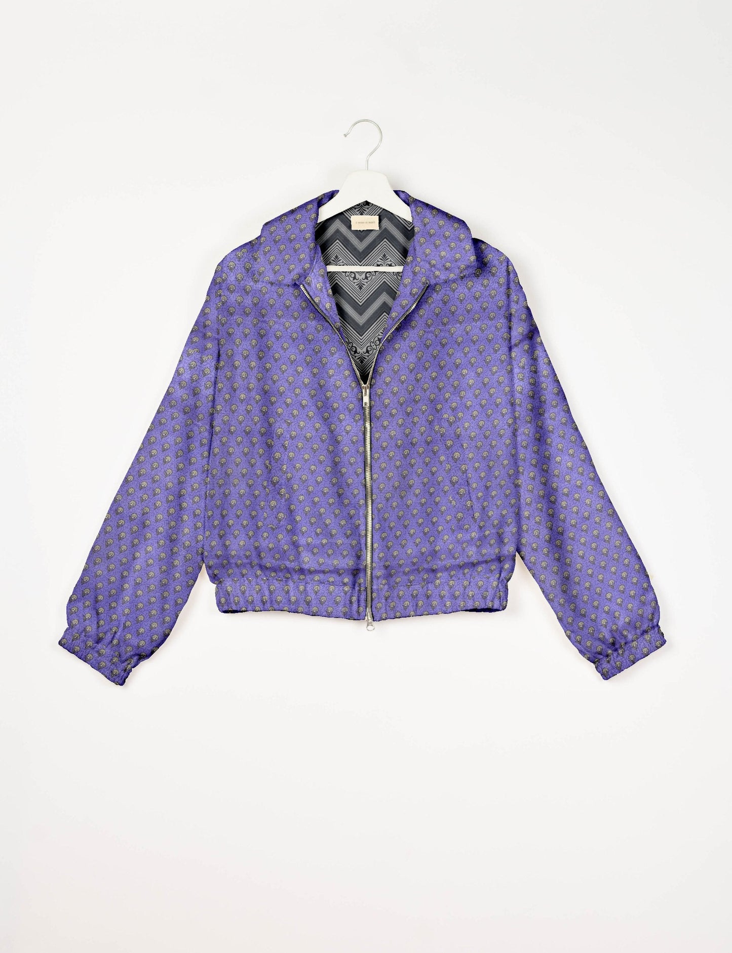 Stylish BOMBER JACKET, an upcycled clothing masterpiece with a cute cropped shape, elasticated details, and detachable metallic zipper. Contrast sari print lining adds a unique touch. Explore sustainable and eco-friendly fashion.