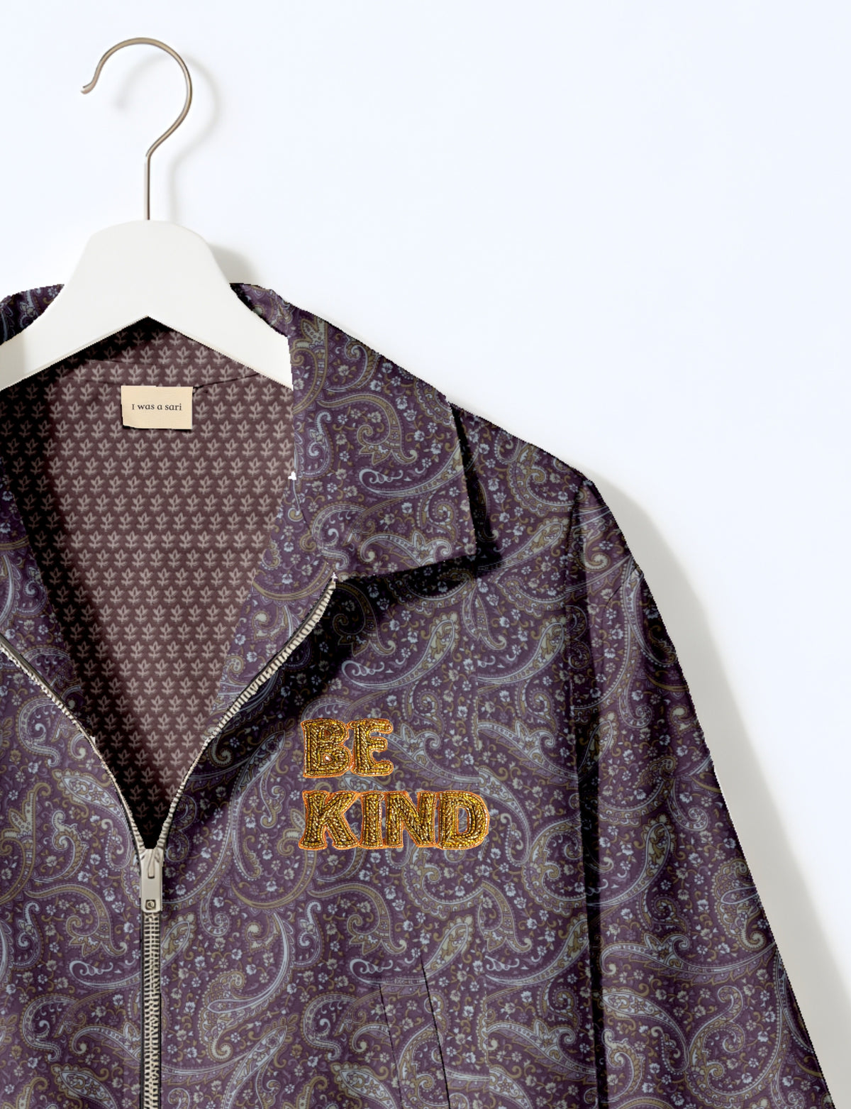 BE KIND Bomber jacket made from upcycled sari fabric with handcrafted Aari embroidery by female artisans.