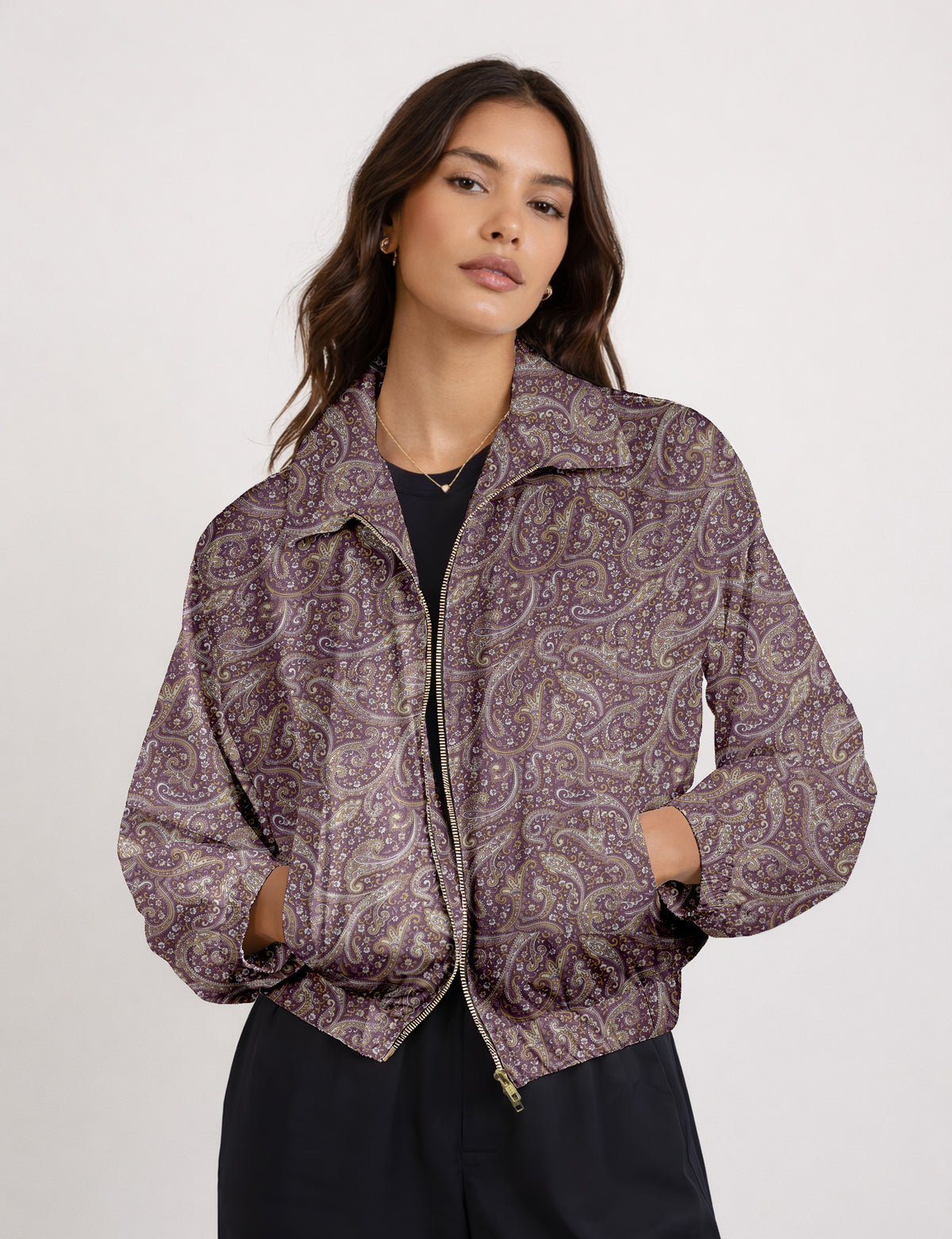 Woman wearing a yellow floral bomber jacket with front zipper, elastic cuffs, and side pockets, shown from front view