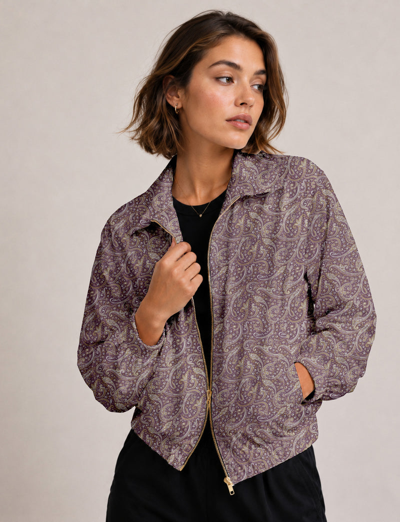 Brown floral bomber jacket with front zipper, elastic cuffs and hem, hanging on white hanger, red floral inner lining visible