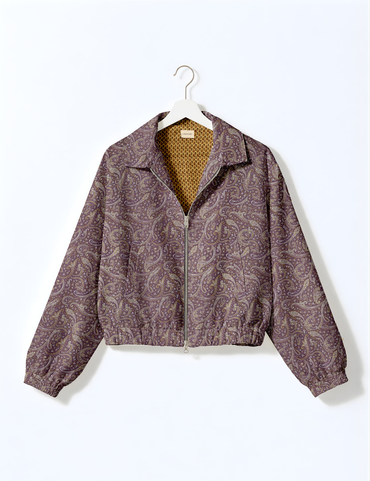 Brown floral bomber jacket with front zipper, elastic cuffs and hem, hanging on white hanger, red floral inner lining visible