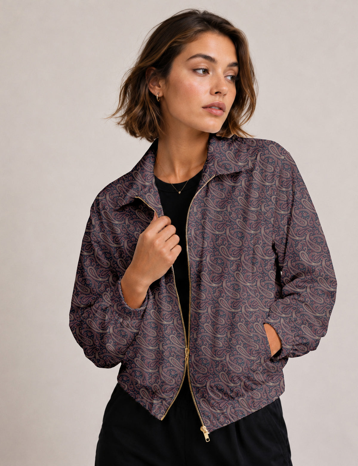 Woman wearing a yellow floral bomber jacket with front zipper, elastic cuffs, and side pockets, shown from front view