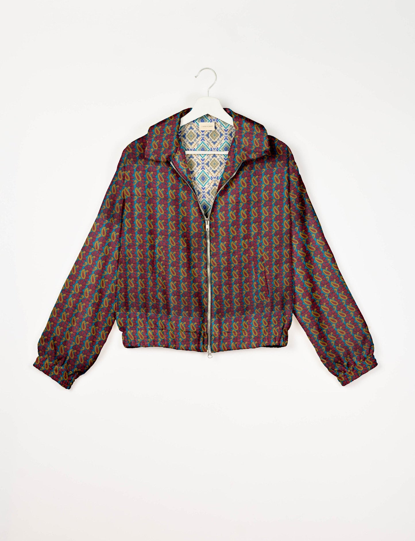 Upcycled Bomber Jacket made from recycled sari materials, featuring a cute cropped shape, elasticated hem and cuffs, and contrast sari print lining. Sustainable apparel promoting eco-friendly fashion and ethical clothing.